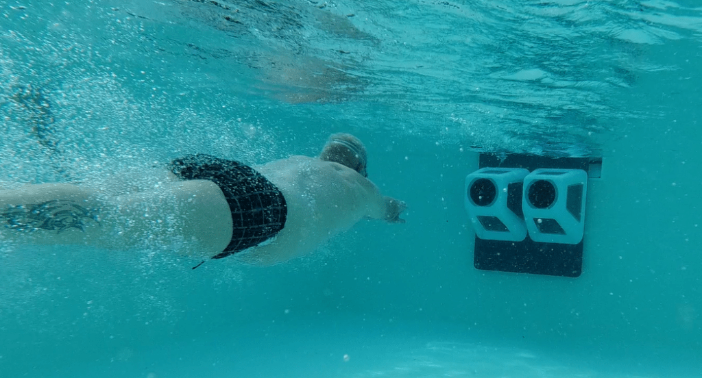 Swimmer swimming against a twin Retrofit SwimJet system